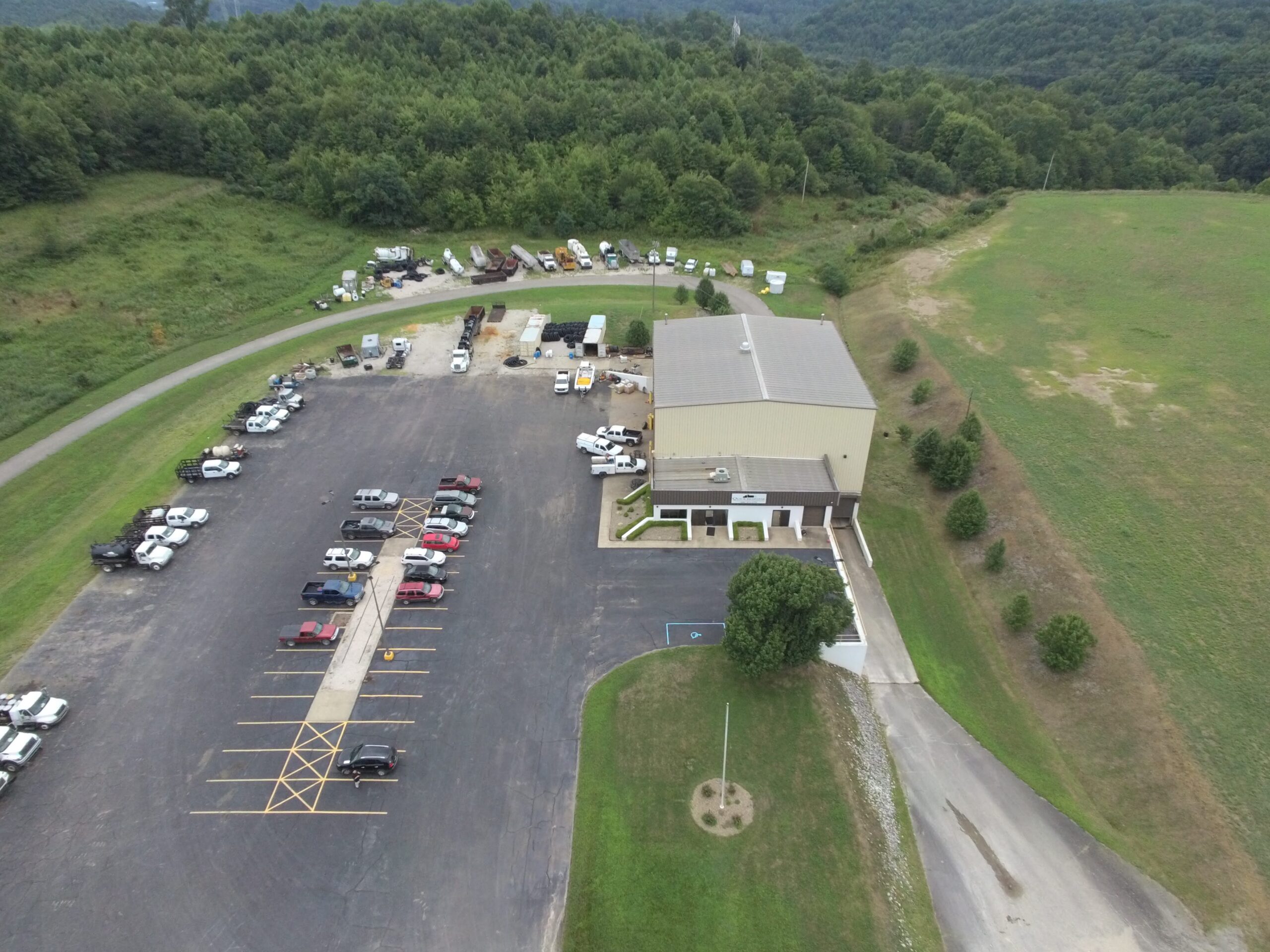 Aerial view of the Quick Response, Inc. facility in Greenup County, Kentucky — main shop, office, parking lot, and equipment yard